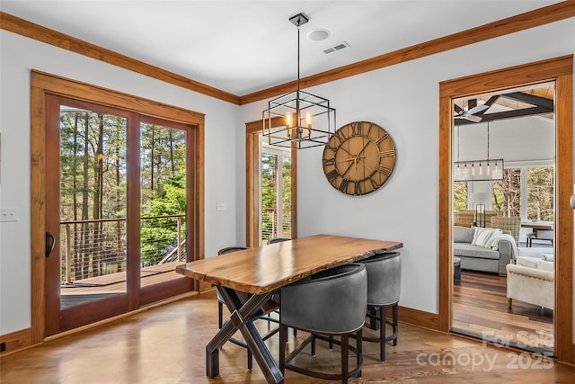 92 Gobblers Neck Dr, Nebo, NC 28761 - dining area with crown molding, visible vents, a wealth of natural light, and wood finished floors
