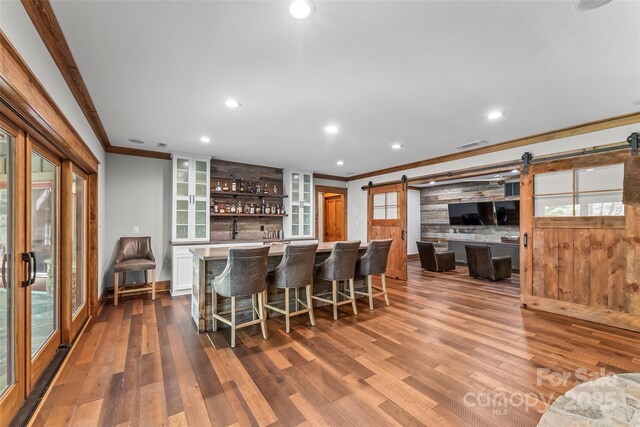 92 Gobblers Neck Dr, Nebo, NC 28761 - bar featuring crown molding, a barn door, bar area, and dark wood-style floors
