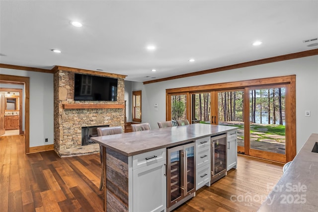 92 Gobblers Neck Dr, Nebo, NC 28761 - kitchen with wine cooler, white cabinets, and crown molding