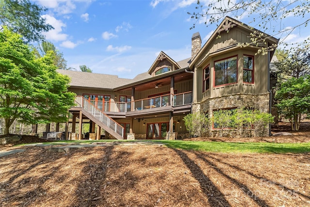 92 Gobblers Neck Dr, Nebo, NC 28761 - back of property with board and batten siding, a ceiling fan, stairway, stone siding, and a chimney