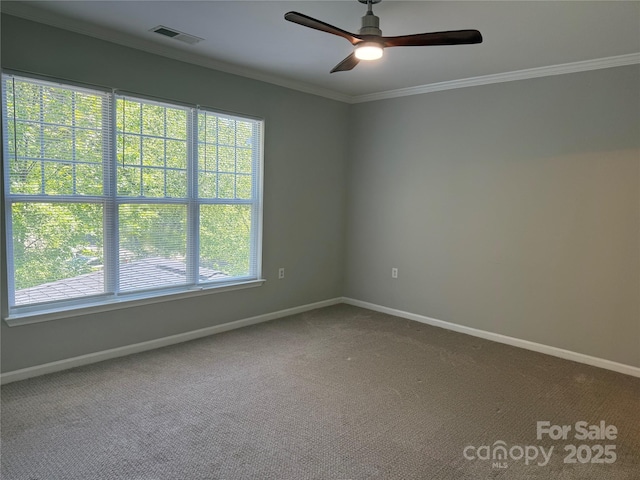 unfurnished room featuring baseboards, crown molding, a ceiling fan, and carpet