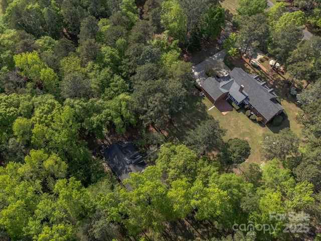 birds eye view of property with a forest view