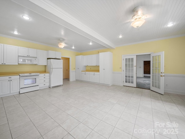 kitchen with crown molding, french doors, light countertops, and white appliances
