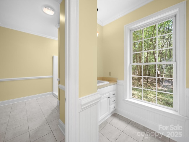 bathroom featuring vanity, ornamental molding, tile patterned flooring, and a wainscoted wall