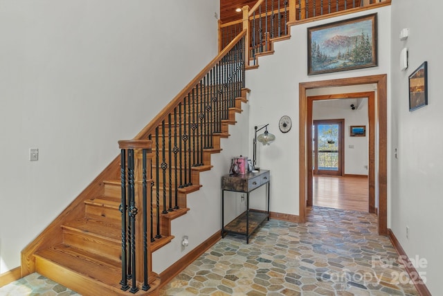 498 Pinnacle Pkwy, Union Mills, NC 28167 - stairway featuring baseboards, stone flooring, and a high ceiling