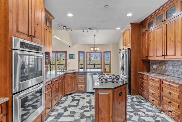 498 Pinnacle Pkwy, Union Mills, NC 28167 - kitchen featuring stainless steel appliances, a peninsula, brown cabinets, and a sink
