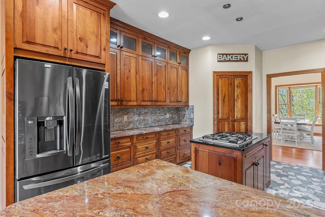 498 Pinnacle Pkwy, Union Mills, NC 28167 - kitchen with brown cabinetry, appliances with stainless steel finishes, and light stone counters