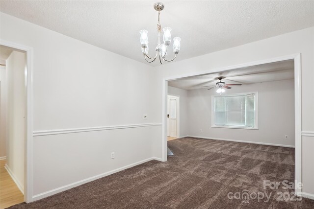 spare room featuring baseboards, carpet, and ceiling fan with notable chandelier