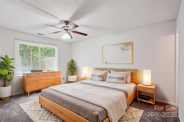 bedroom with carpet floors, a ceiling fan, baseboards, and visible vents