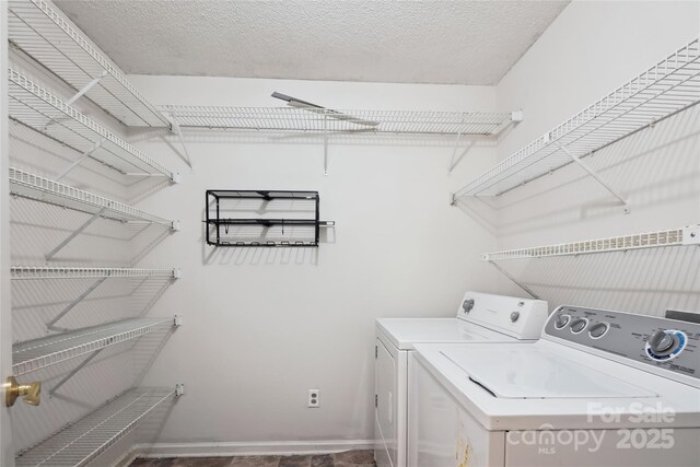 laundry room with baseboards, laundry area, and washer and dryer
