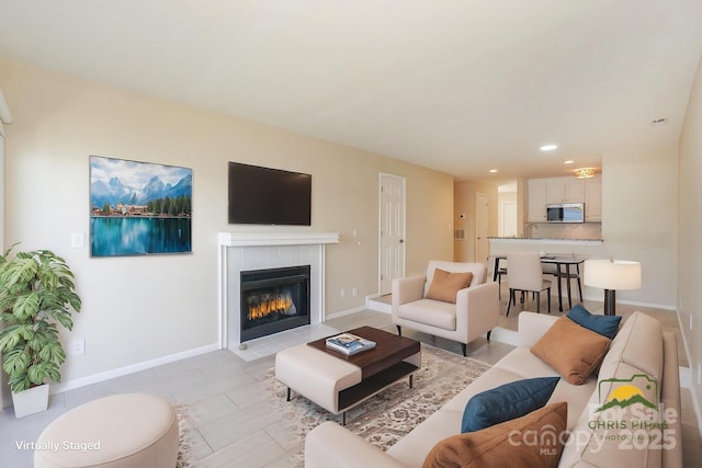 368 NW Dr, Davidson, NC 28036 - living room featuring a tiled fireplace, baseboards, and recessed lighting