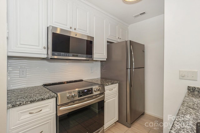 368 NW Dr, Davidson, NC 28036 - kitchen featuring visible vents, white cabinetry, backsplash, and appliances with stainless steel finishes