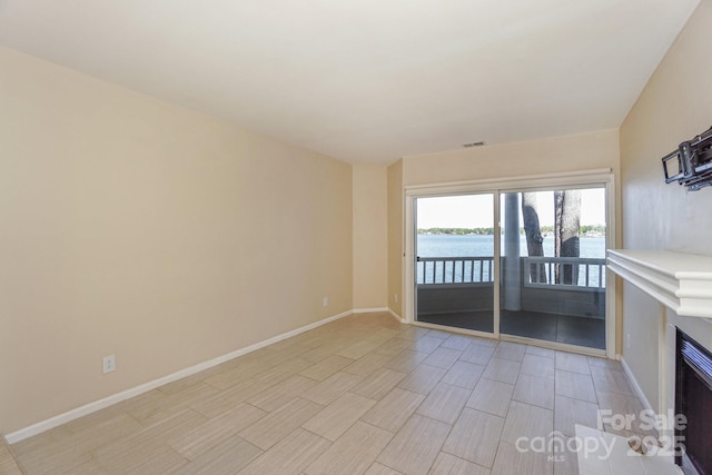 368 NW Dr, Davidson, NC 28036 - unfurnished living room with a water view, visible vents, and baseboards