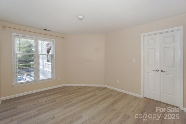 368 NW Dr, Davidson, NC 28036 - empty room with light wood-style flooring, baseboards, and visible vents