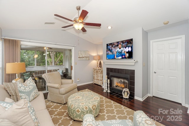 765 SW Dr, Davidson, NC 28036 - living area featuring wood finished floors, a tiled fireplace, vaulted ceiling, and ceiling fan