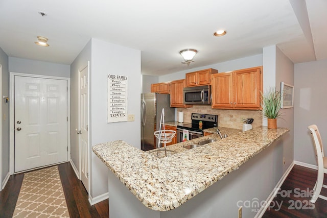 765 SW Dr, Davidson, NC 28036 - kitchen with backsplash, appliances with stainless steel finishes, baseboards, and light stone counters