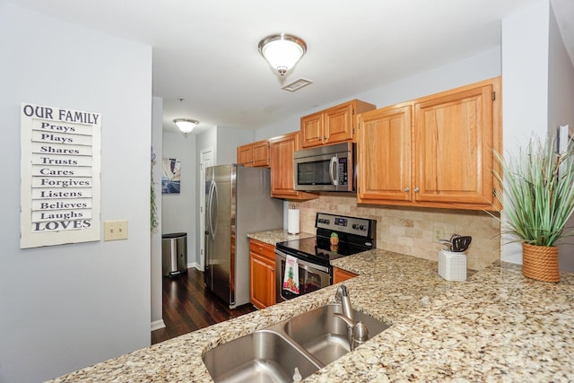 765 SW Dr, Davidson, NC 28036 - kitchen with light stone countertops, visible vents, a sink, stainless steel appliances, and backsplash
