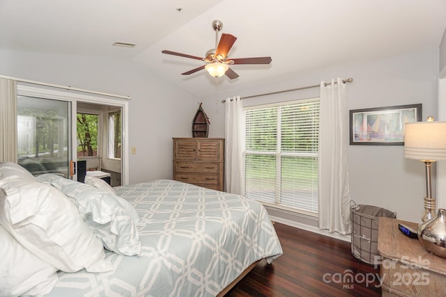 765 SW Dr, Davidson, NC 28036 - bedroom with dark wood-style floors, visible vents, access to exterior, multiple windows, and lofted ceiling