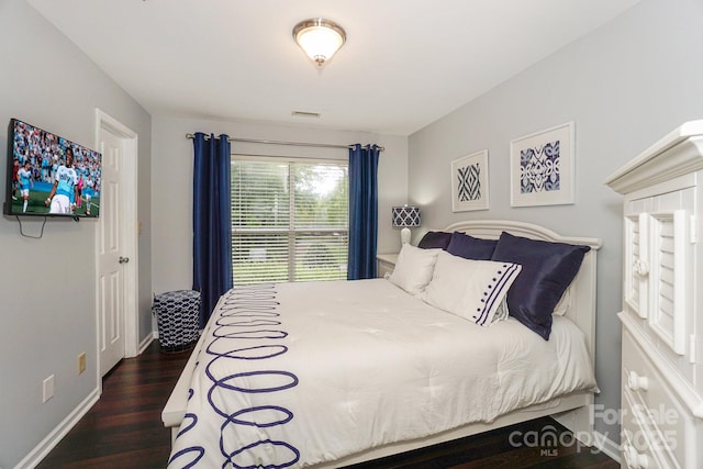 765 SW Dr, Davidson, NC 28036 - bedroom featuring dark wood-type flooring, visible vents, and baseboards