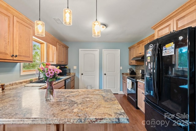 1091 Bill Collins Rd, Columbus, NC 28722 - kitchen featuring black appliances, under cabinet range hood, dark wood finished floors, light brown cabinets, and pendant lighting