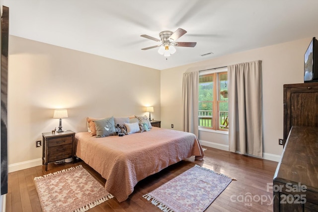 1091 Bill Collins Rd, Columbus, NC 28722 - bedroom featuring baseboards, wood finished floors, and a ceiling fan