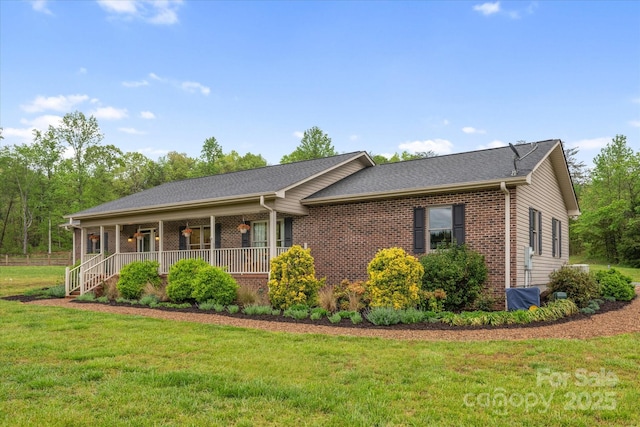 1091 Bill Collins Rd, Columbus, NC 28722 - view of front of property with covered porch, a front lawn, and brick siding