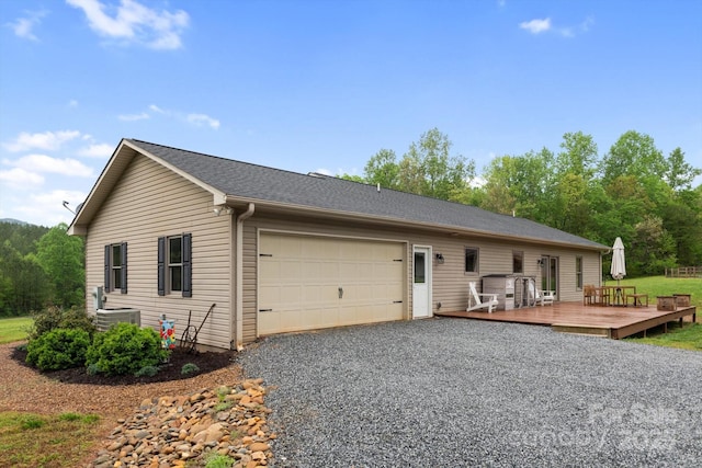 1091 Bill Collins Rd, Columbus, NC 28722 - view of front of property featuring a garage, driveway, a wooden deck, and central AC