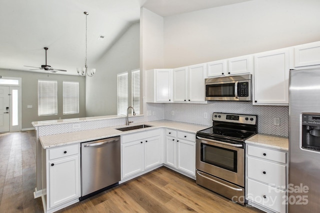 101 N Ferncliff Dr, Mount Holly, NC 28120 - kitchen featuring a sink, ceiling fan, appliances with stainless steel finishes, a peninsula, and decorative backsplash