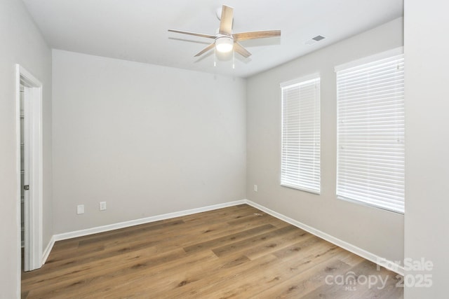 101 N Ferncliff Dr, Mount Holly, NC 28120 - spare room with visible vents, baseboards, a ceiling fan, and wood finished floors