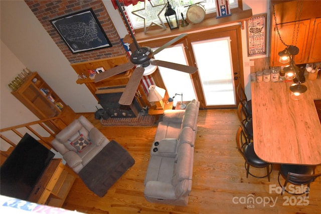 living area featuring ceiling fan and wood finished floors