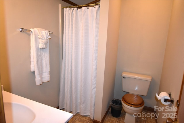 full bathroom with baseboards, toilet, and curtained shower