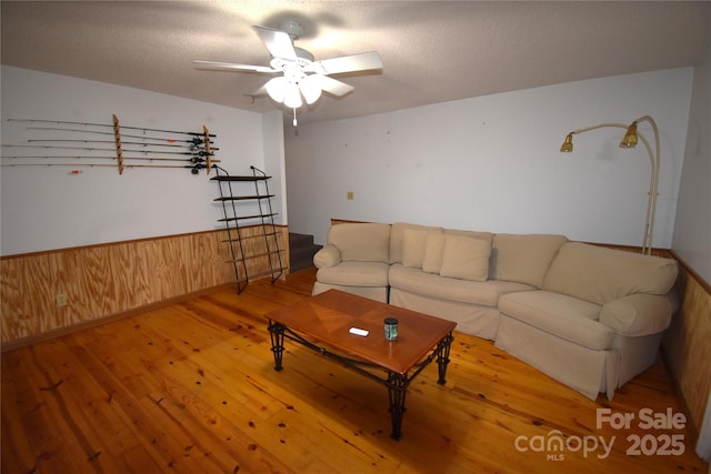 living room featuring ceiling fan and wood finished floors