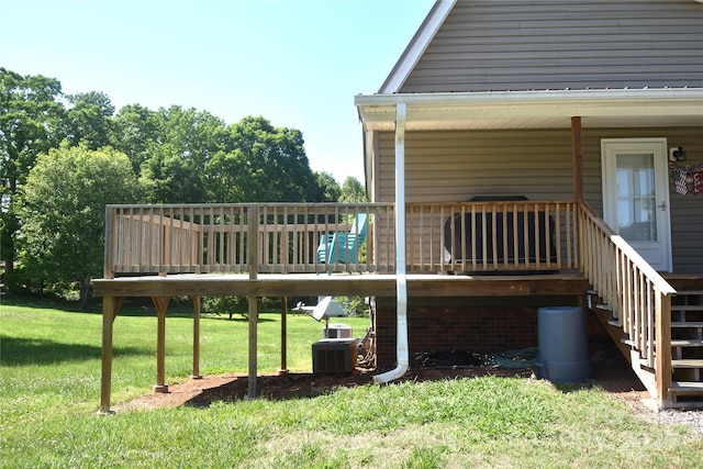 wooden deck featuring a lawn, stairs, and central air condition unit