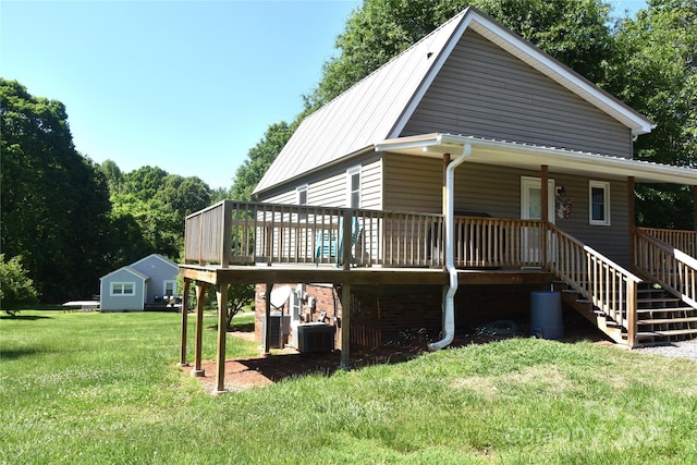 back of house with a yard, central AC, and stairway