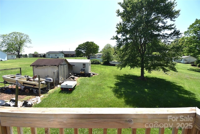 view of yard featuring an outdoor structure and a storage unit