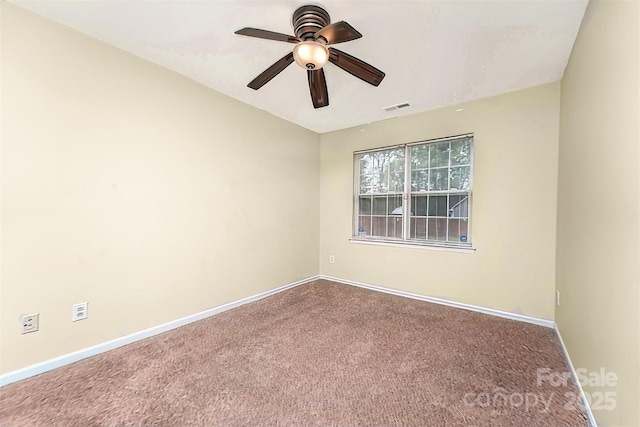 carpeted empty room featuring baseboards, a ceiling fan, and visible vents