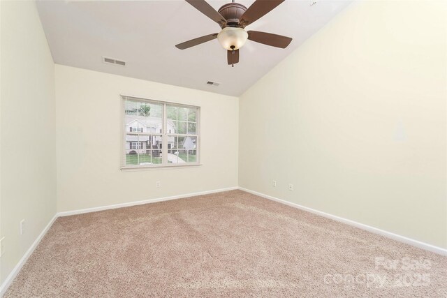 carpeted spare room featuring ceiling fan, baseboards, and visible vents