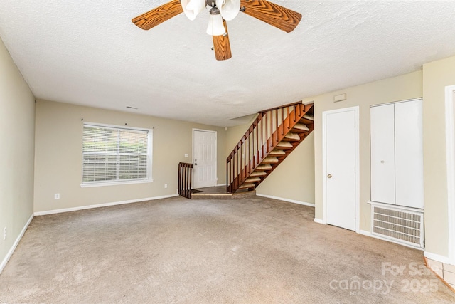 unfurnished living room with stairway, visible vents, a ceiling fan, and carpet