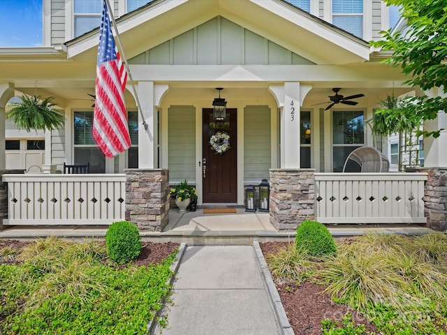 view of exterior entry with covered porch and board and batten siding
