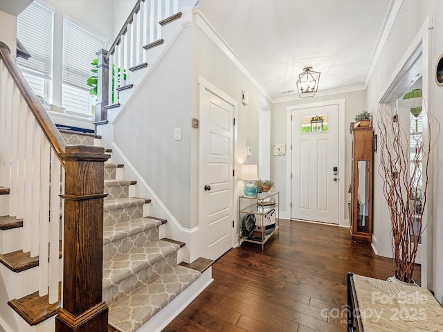 entryway featuring stairway, a wealth of natural light, and hardwood / wood-style flooring