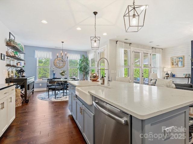 kitchen featuring stainless steel dishwasher, a sink, gray cabinetry, dark wood-style floors, and recessed lighting