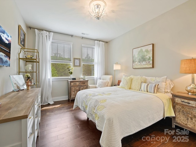 bedroom featuring baseboards, visible vents, and dark wood-style floors