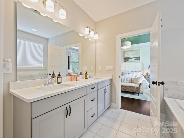 full bathroom with visible vents, ensuite bath, tile patterned flooring, and a sink