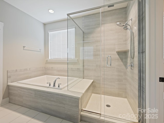 bathroom featuring a bath, tile patterned flooring, and a shower stall