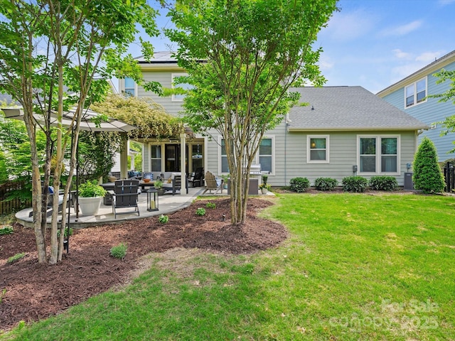 back of property with a lawn, central AC, and a patio area