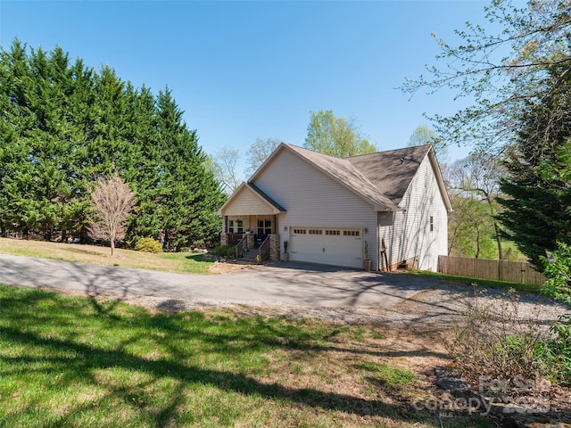 18 Birdsong Ln, Candler, NC 28715 - view of home's exterior featuring fence, a lawn, a garage, and driveway