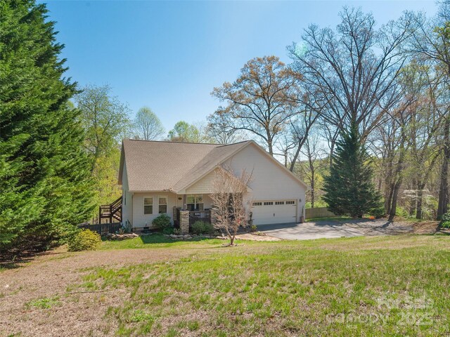 18 Birdsong Ln, Candler, NC 28715 - view of front of home featuring a porch, driveway, a garage, and a front yard