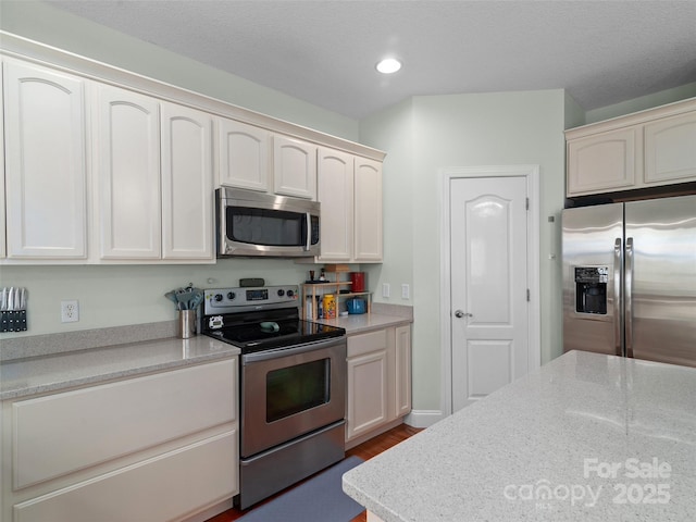 18 Birdsong Ln, Candler, NC 28715 - kitchen with dark wood-type flooring, recessed lighting, white cabinets, and stainless steel appliances