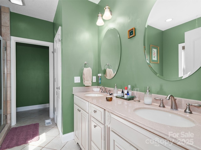 18 Birdsong Ln, Candler, NC 28715 - bathroom with an enclosed shower, double vanity, a sink, and tile patterned flooring