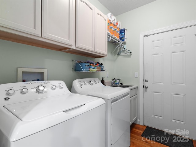 18 Birdsong Ln, Candler, NC 28715 - washroom with separate washer and dryer, a sink, dark wood finished floors, and cabinet space